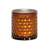 Brown textured glass candle with lid on a white background