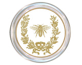 Round coaster with gold bee and laurel wreath design on a white background