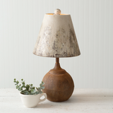 This antiqued lamp features an iron cannon ball base and a metal lampshade that has distressed colors. It takes a standard light bulb which is not included. 60-watts is the maximum suggested bulb wattage for this item. The cannon ball measures 6'' dia. Poplar Landing JaBella Designs