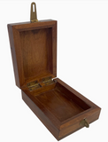 Wooden box with brass hinges and latch on a white background