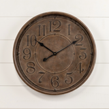 Bronze wall clock on a white wooden background