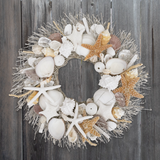 Decorative wreath with seashells, starfish, and coral on a wooden background