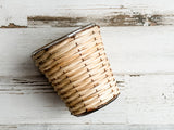 Bamboo &amp; copper votive candle holder

Bring a natural element into your home with our bamboo- and copper-wrapped glass votive candle holders. Each votive is expertly crafted and handwoven from sustainably sourced bamboo. Add it to a table or shelf for a glowing fixture that sets the mood of your chosen theme.

Materials:
Glass, copper, bamboo

Dimensions:
2 3/4" diameter x 3 1/4" high
