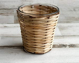Bamboo &amp; copper votive candle holder

Bring a natural element into your home with our bamboo- and copper-wrapped glass votive candle holders. Each votive is expertly crafted and handwoven from sustainably sourced bamboo. Add it to a table or shelf for a glowing fixture that sets the mood of your chosen theme.

Materials:
Glass, copper, bamboo

Dimensions:
2 3/4" diameter x 3 1/4" high