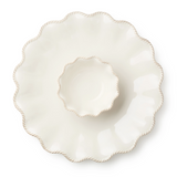 White ceramic plate with scalloped edge on a white background