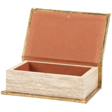  This small decorative book box is inspired by rustic cabin decor. It features a textured faux leather wrap displaying the exterior of a vintage book with an aged metallic gold finish on an embossed deer emblem design. It also displays a coordinating embossed gold design on its side to give the appearance of a book spine when on a shelf. 