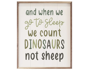 'We Count Dinosaurs Not Sheep' wall sign

This unique piece is a simple way to bring whimsical charm to a nursery or playroom. It features the phrase, "and when we go to sleep we count dinosaurs not sheep," in green font. It is made from high-quality American hardwood planks with a hand painted face, and printed with UV cured ink, and is framed in a natural walnut frame. Each piece is unique with its own personality, marks, wood grain, and look.&nbsp;

This item is proudly made in the USA.

Materials:
Wood
