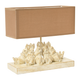Distressed rabbit table lamp with shade

Set a relaxing tone in your home with this group of sleeping bunnies. The light from the lamp spotlights how precious and content these little friends are and passes that feeling on to you. The base has a white washed finish. Let these sleepy friends be the light in your room.

Materials:
Resin, linen fabric

Dimensions:
13" high x 5 1/2" wide x 14" long