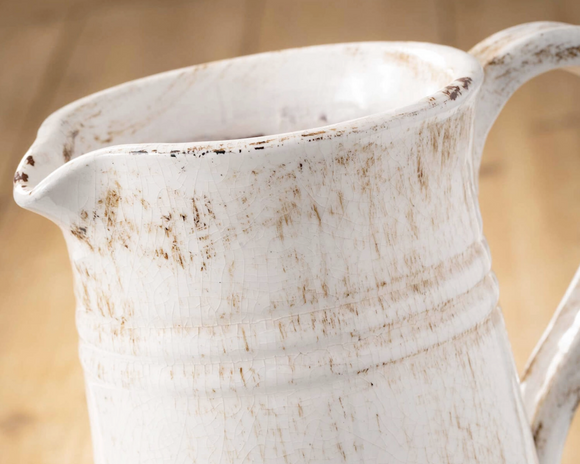 Glazed ceramic distressed ivory pitcher

You'll love how this pure and graceful ceramic pitcher. Neutral finishes allow for it to blend seamlessly into any style and color scheme, making it perfect for almost any environment. It is waterproof and safe for use with cool liquids.

Materials:
Ceramic

Dimensions:
8