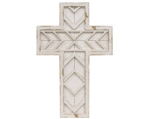 Decorative white cross with geometric patterns on a white background
