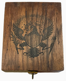 Wooden box with engraved coat of arms on a white background