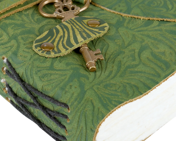 This gorgeous journal features an embossed floral pattern on a dark green leather cover. Inside contains 200 unlined pages featuring deckled edges to pen anything that is desired. Our journal includes a leather tie attached to an antique key that slides into a pocket to keep journal secure, make this a perfect vintage-inspired accessory perfect for any home office or desk.