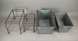 Set of metal planters and stands on a gray background