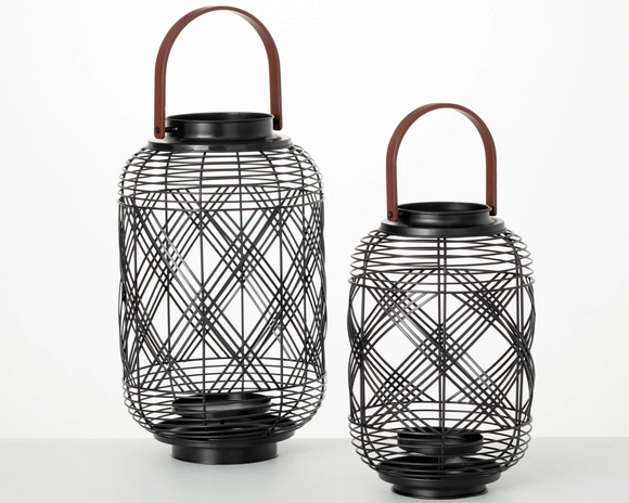Two black wire lanterns with handles on a white background