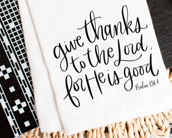 Textile with 'Give thanks to the Lord for He is good' quote on a white background