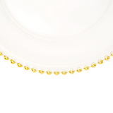 Gold beaded plate charger on a white background