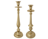 Two gold candlesticks on a white background