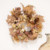 Autumn-themed wreath with leaves and berries on a white background