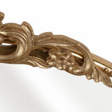 This stunning gold metallic wall mirror features an antique-inspired gold design. The mirror is accented at the top with a floral filigree embellishment. It enhances your decor while the high-quality finish ensures long-lasting beauty, perfect for living rooms, bedrooms, and entryways.&nbsp;

Materials:
Metal, glass

Dimensions:
36" wide x 38" high