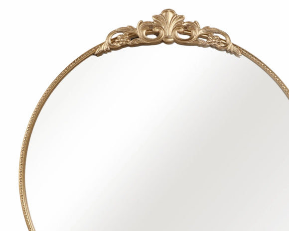 This stunning gold metallic wall mirror features an antique-inspired gold design. The mirror is accented at the top with a floral filigree embellishment. It enhances your decor while the high-quality finish ensures long-lasting beauty, perfect for living rooms, bedrooms, and entryways. 

Materials:
Metal, glass

Dimensions:
36