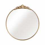 Round mirror with gold decorative frame on a white background