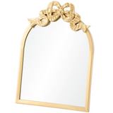 Gold-framed mirror with decorative bow design on a white background