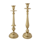 Two gold candle holders on a white background