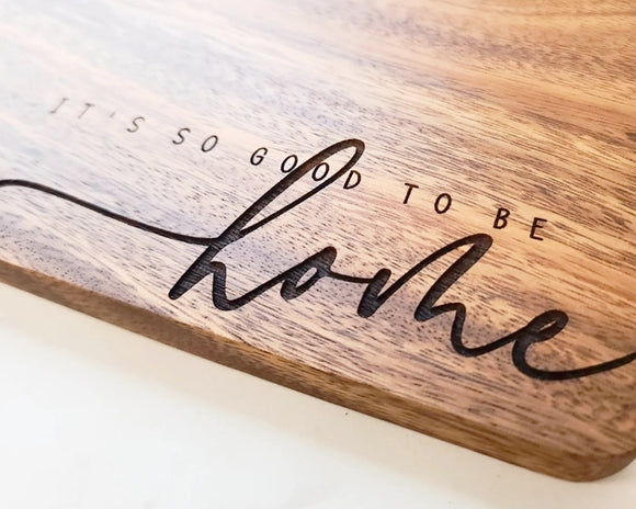 'It's So Good To Be Home' cutting board
*Made to order*

Cut on the blank side. Flip it to serve! This handmade board is engraved with 