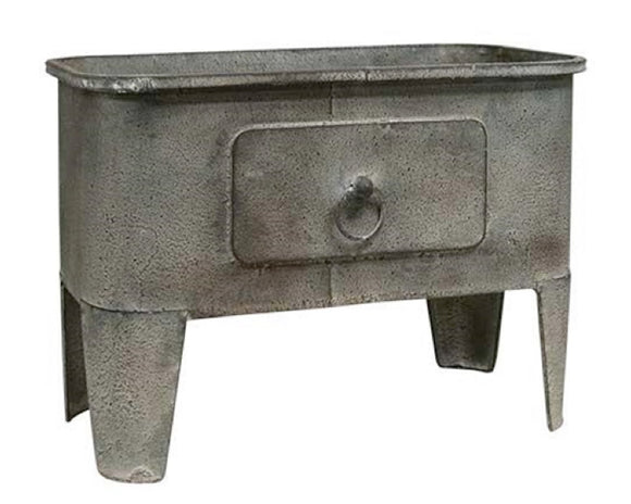 Whether used to display your favorite artificial plant or to hold small household items, this metal basin coordinates well with almost all styles of decor, including classic country and rustic farmhouse. It features a distressed gray finish and has a decorative drawer along the front for added character. This is a charming piece that is sure to please just about everyone.