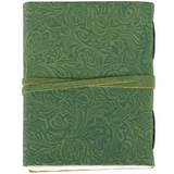 Green embossed leather notebook with a strap closure on a white background