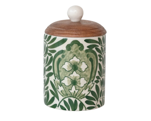 This round stoneware canister with a botanical design and acacia wood lid is a delightful addition to any countertop. Its round shape and natural green palette evoke a sense of calm, reminiscent of a garden in bloom. The acacia wood lid fits snugly, preserving the contents while adding a touch of rustic elegance. Whether used for storing tea, coffee, or sweet treats, or simply as an accent piece, this canister is a functional yet decorative element that complements farmhouse, Scandinavian, or rustic decor w