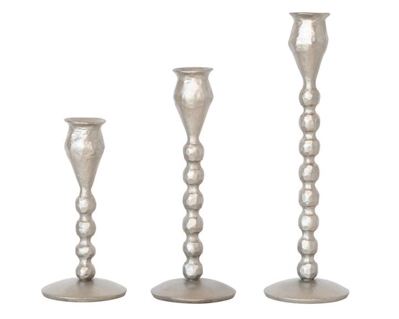 Lot of antique silver ball taper candle holders

Add unique charm to an entryway or bathroom with these candle holders. Each one features an antique silver finish accented with multiple balls along the stem. These candle holders make for a great wedding gift as well.

These candle holders are sold in sets of three, one of each size.

Materials:
Iron

Dimensions:
Shortest candlestick -
2 3/4