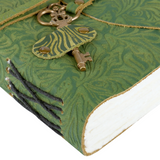 Green leather-bound book with decorative key and latch on a white background