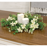 Floral arrangement with candles on a wooden surface