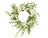 Floral wreath with white flowers and green leaves on a white background