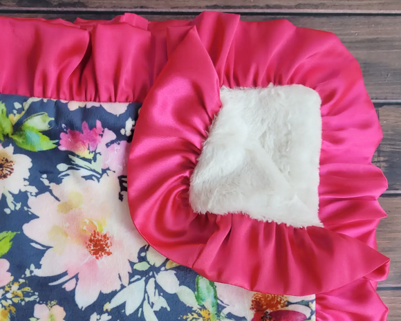 Navy blue floral baby blanket with hot pink satin trim