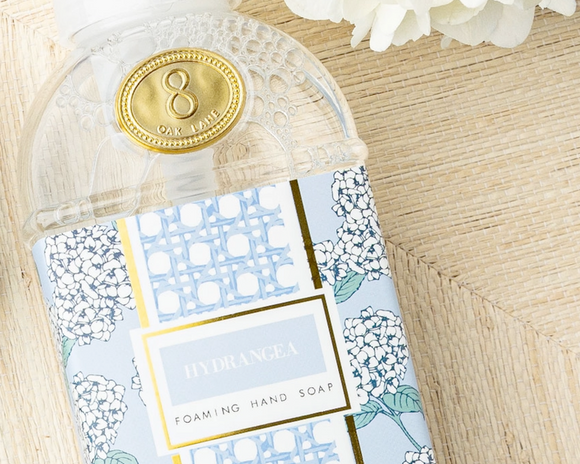 Hand soap packaging with floral design on a wooden surface