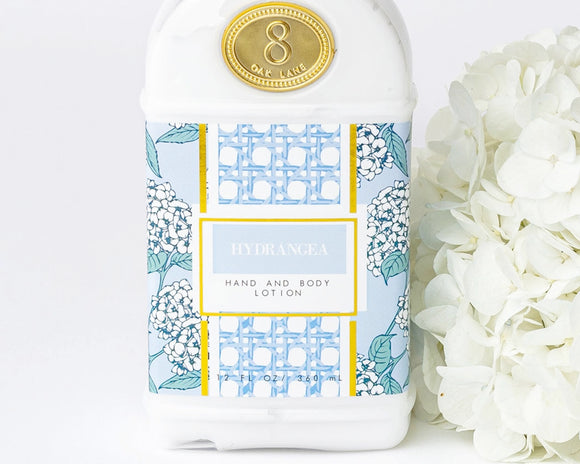 Hand and body lotion bottle with floral design and gold label on a white background