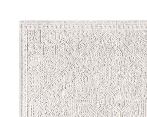 White textured diamond patterned rug on a white background