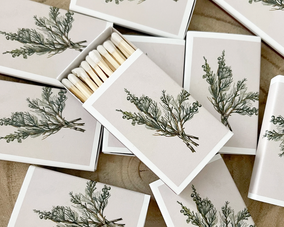 Matches with green leaf design on a wooden surface