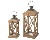 Set of two nesting farmhouse wood lanterns in varying sizes with dark metal top caps and open-air frames, displayed flat on a clean neutral surface.