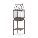 Decorative metal plant terrarium design on a white background