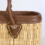 Rectangular straw tote with leather accents

This rectangular straw tote with genuine leather accents is an essential accessory for your shopping needs. This bag is not only practical, it also carries the heritage of longtime artisans. It is ideal for use in the home, kitchen, or even for organization.&nbsp;

Materials:
Wicker, leather

Dimensions:
11" high x 6" deep x 16 1/2" wide

Care:
Spot-clean only
