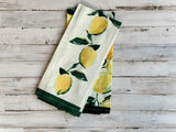 Set of kitchen towels with lemon design on a wooden surface