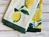 Set of lemon kitchen towels with lemon design on a wooden surface