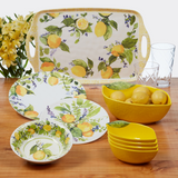 Dishware set with lemon-themed design on a wooden table