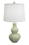 Green lamp with a white shade on a white background