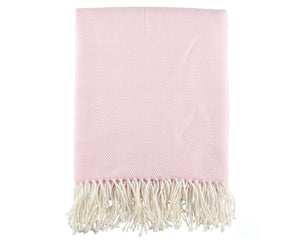 Pink throw blanket with white fringe on a white background
