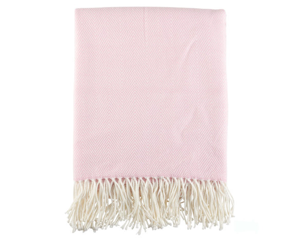 Pink throw blanket with white fringe on a white background