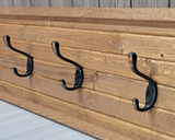 Rustic American-made light pine coat rack
*Made to order*

This rustic wood coat rack is great for hanging many items including coats, hats, towels aprons and many more. The coat racks are made using a solid pine board that is then covered and framed with rough-sawn wooden slats. Metal coat hooks are secured through both layers of wood with screws. Each coat rack is handmade using natural wood so every item will be unique. The wood may have knots, cracks, nail holes and natural wear in the finish.&nbsp;
